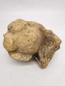 A carved limestone finial allegedly from Lincoln cathedral. H.18 W.16 D.13cm.