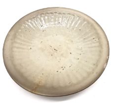 A Chinese Ming dynasty pale celadon Longquan dish with sunburst decoration and glazed foot. Diameter