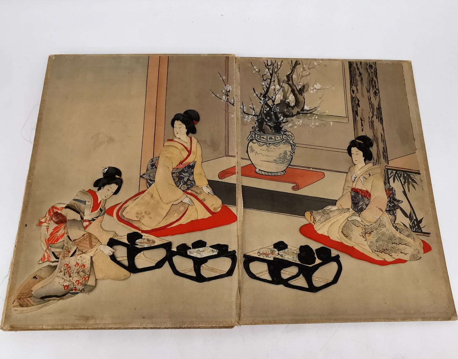 A Meji period Japanese fold out Oshie panels depicting scenes of Geishas receiving visitors. The