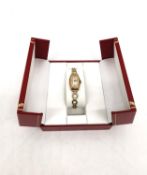 A ladies Art Deco 9ct yellow gold Rolex automatic watch with rolled gold curricular link bracelet.