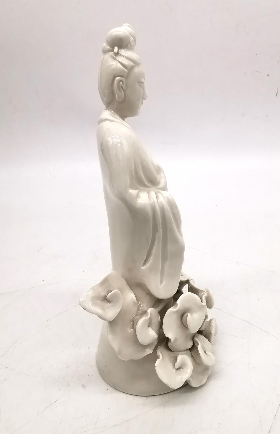 A Chinese 19th century blanc de chine figure of Guanyin surrounded by stylised clouds. H.21 W.11cm. - Image 5 of 7