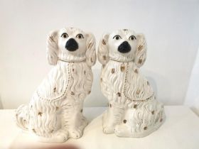 A pair of very large 19th century Staffordshire pottery spaniels with gold chain collars and painted