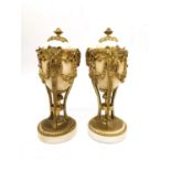 A pair of Louis XVI style gilt mounted marble cassolette candlesticks, the combination tops