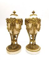 A pair of Louis XVI style gilt mounted marble cassolette candlesticks, the combination tops