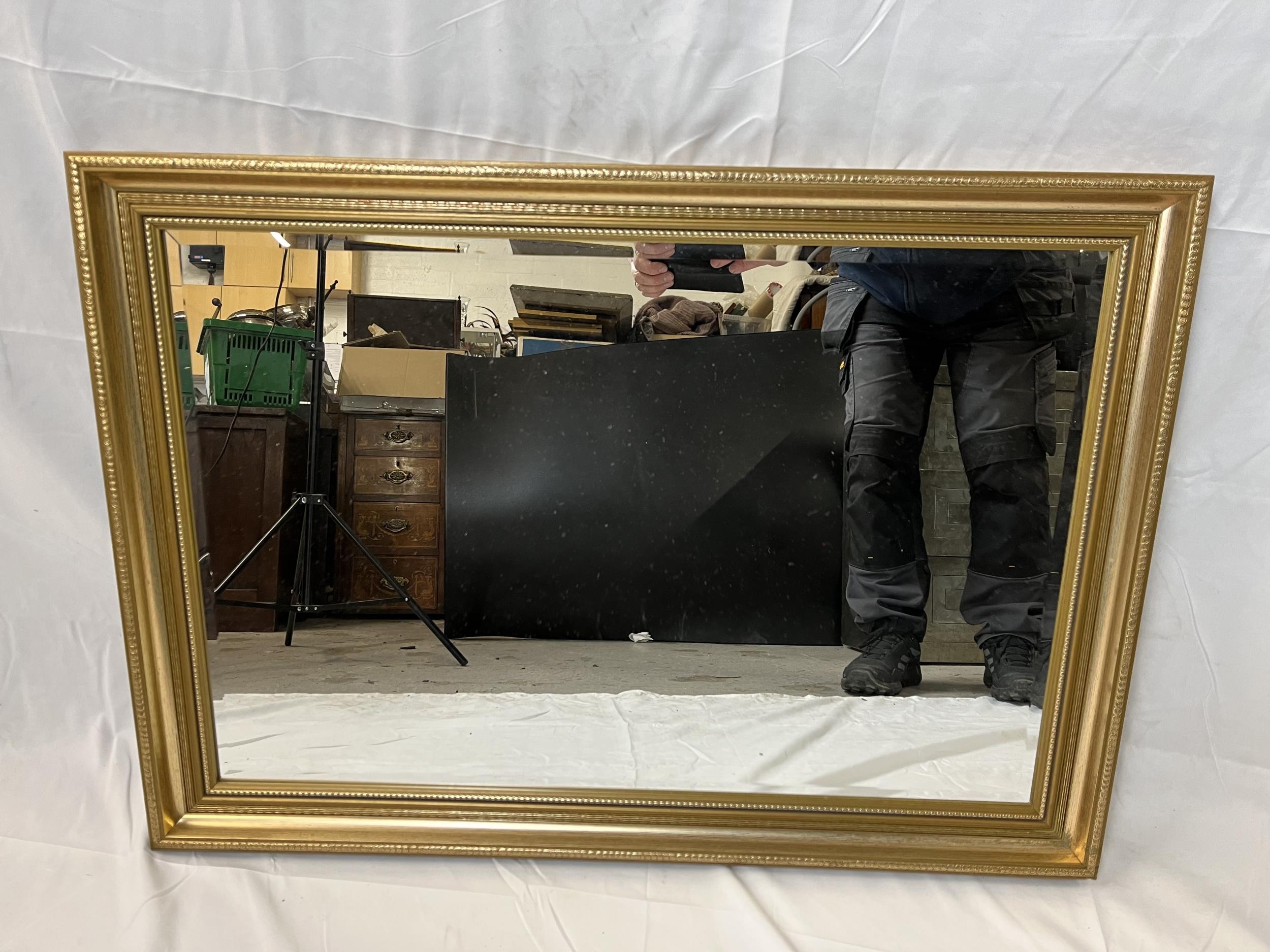 A contemporary gilt mirror with bevelled plate. H.61 W.84cm.