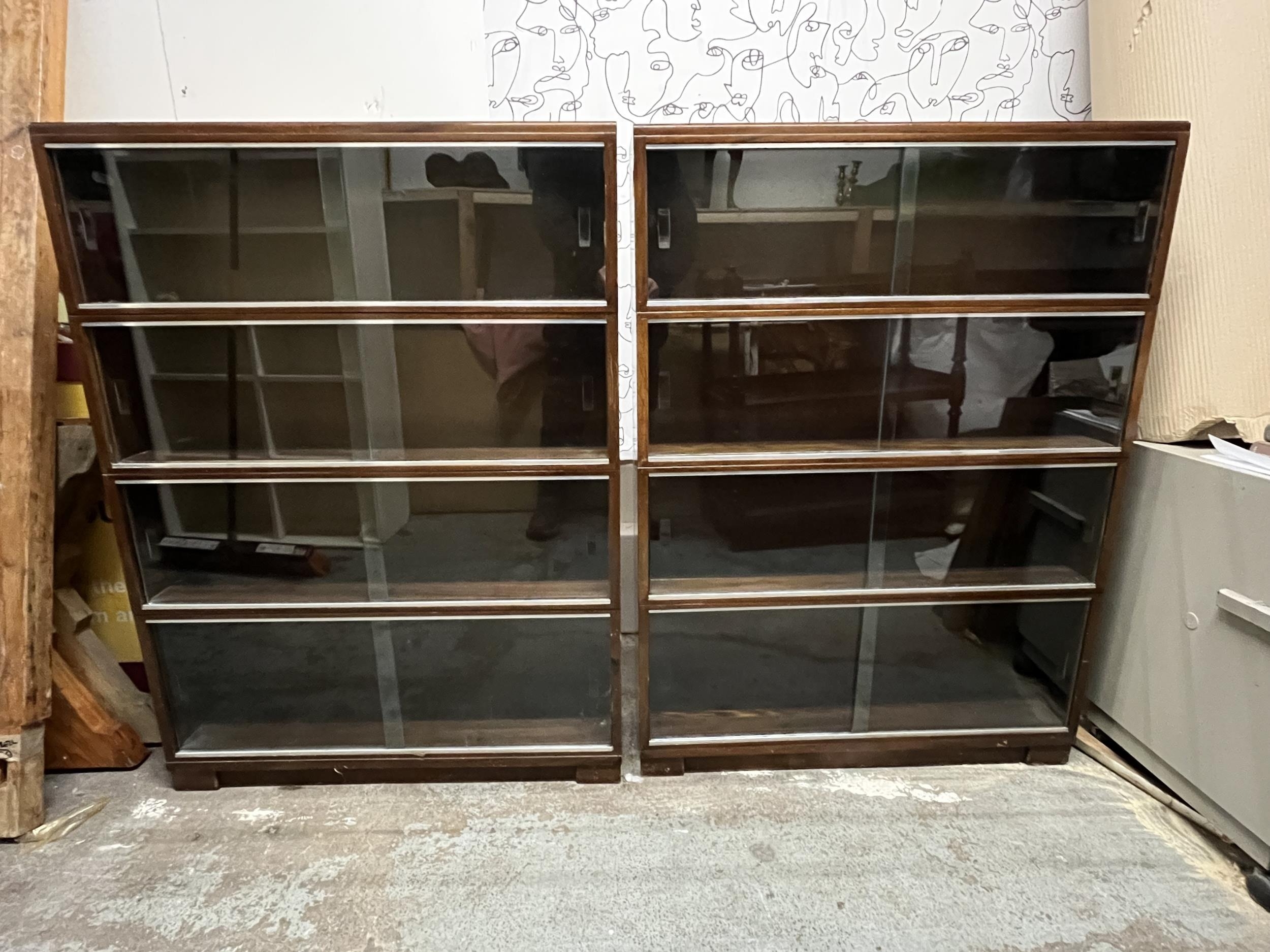 Bookcases, a pair mid century teak with plate glass sliding doors. H.121 W.89 D.23cm.