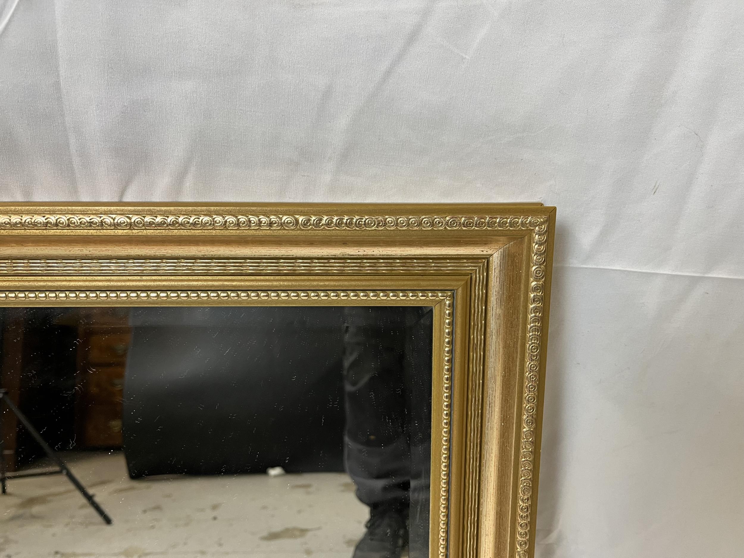 A contemporary gilt mirror with bevelled plate. H.61 W.84cm. - Image 3 of 4