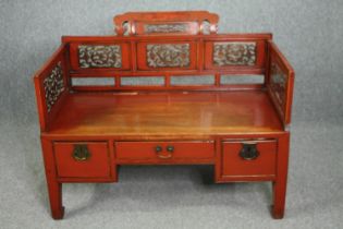 A 19th century Chinese window seat, lacquered polychrome and carved fitted with drawers to the base.