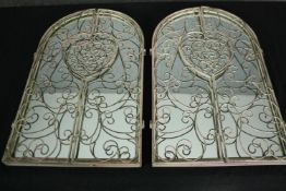 A pair of distressed painted mirrors with wrought metal doors. H.50 W.31cm. (each)