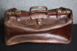 A vintage leather Gladstone bag. H.27 W.60 D.50cm.