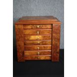 A burr elm specimen or vanity chest with rising mirror to the top and hinged locking stile side