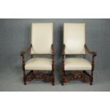 Throne style armchairs, a pair, C.1900 Carolean style oak in studded ivory leather upholstery. H.