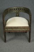 Tub armchair, Eastern hardwood with embossed metal decoration. H.69 W.62 D.62cm.