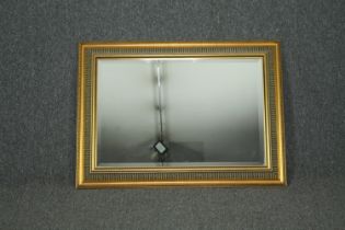 Wall mirror, contemporary gilt framed with bevelled plate. H.69 W.93cm.