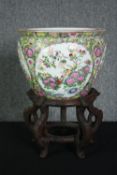 A 20th century Famille Rose fish bowl on hardwood stand. H.45 Dia.31cm. (Bowl)