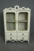 A wall hanging cabinet in the form of a dresser. painted Continental style. H.92 W.60 D.19cm.