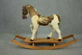 A vintage rocking horse in cowhide covering. H.74 W.110 D.38cm.