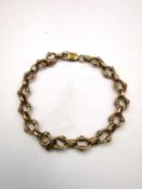 A 9ct rose gold oval fancy oval link chain bracelet with secure lobster clasp. Hallmarked:375,