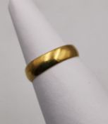 A yellow metal (tests as 22ct gold) wide D-shape band. Indistinct marks. Ring size L. Weight 2.58g.