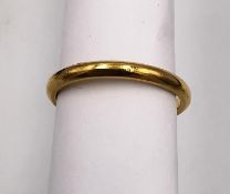 A 22 carat yellow gold D-shape wedding band. Full English hallmarks. Ring size K. Weight 2.67g.