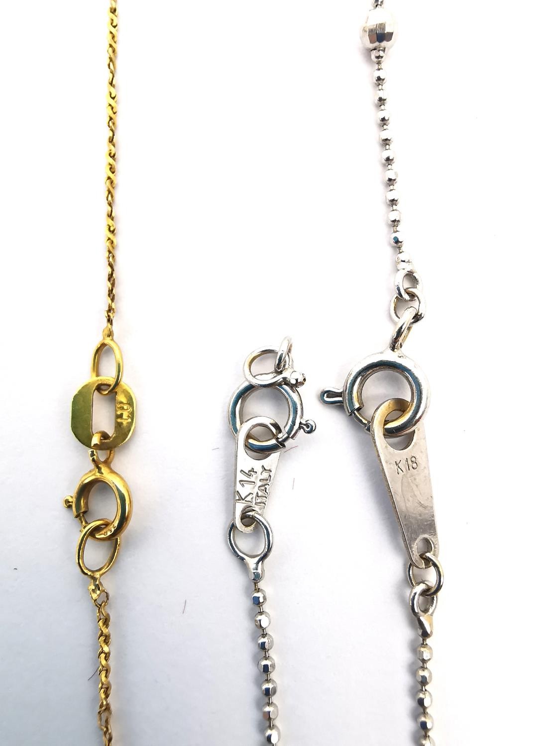 Three broken gold chain link necklaces. A 14ct white gold ball link chain. (Weight 1.50g). An 18ct - Image 3 of 5