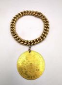 An 18 carat yellow gold curb link bracelet with an Austrian gold 4 ducat 1913 restrike coin.