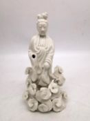 A Chinese 19th century blanc de chine figure of Guanyin surrounded by stylised clouds. H.21 W.11cm.