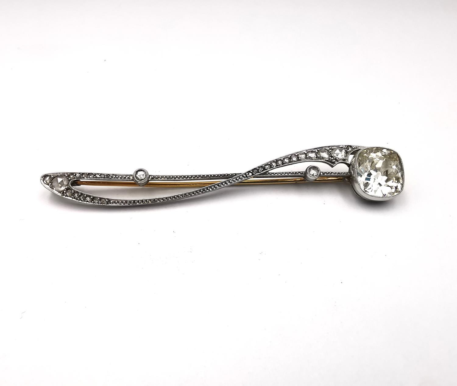 A French early 20th century Art Nouveau design platinum and diamond brooch. Set with a cushion