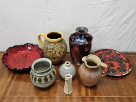 A miscellaneous collection of studio pottery, to include jugs, vases and plates. Tallest vase is