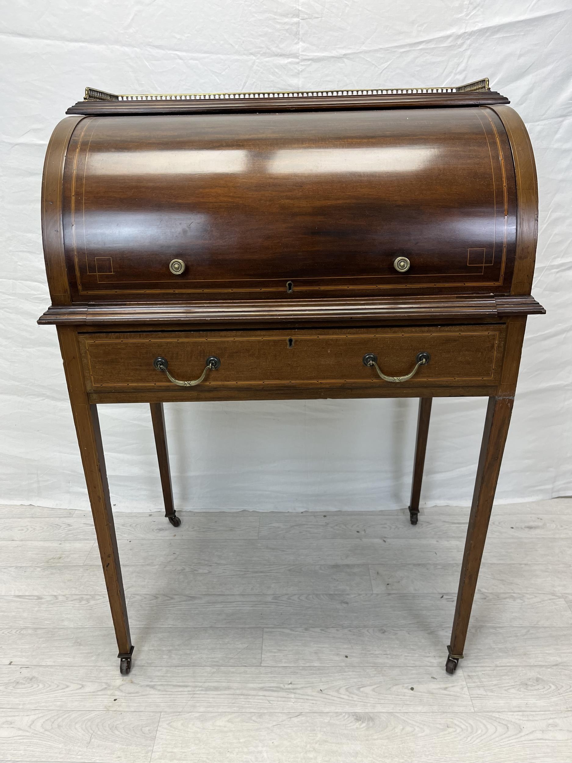 An Edwardian Sheraton style mahogany and satinwood inlaid cylinder bureau with fitted interior and