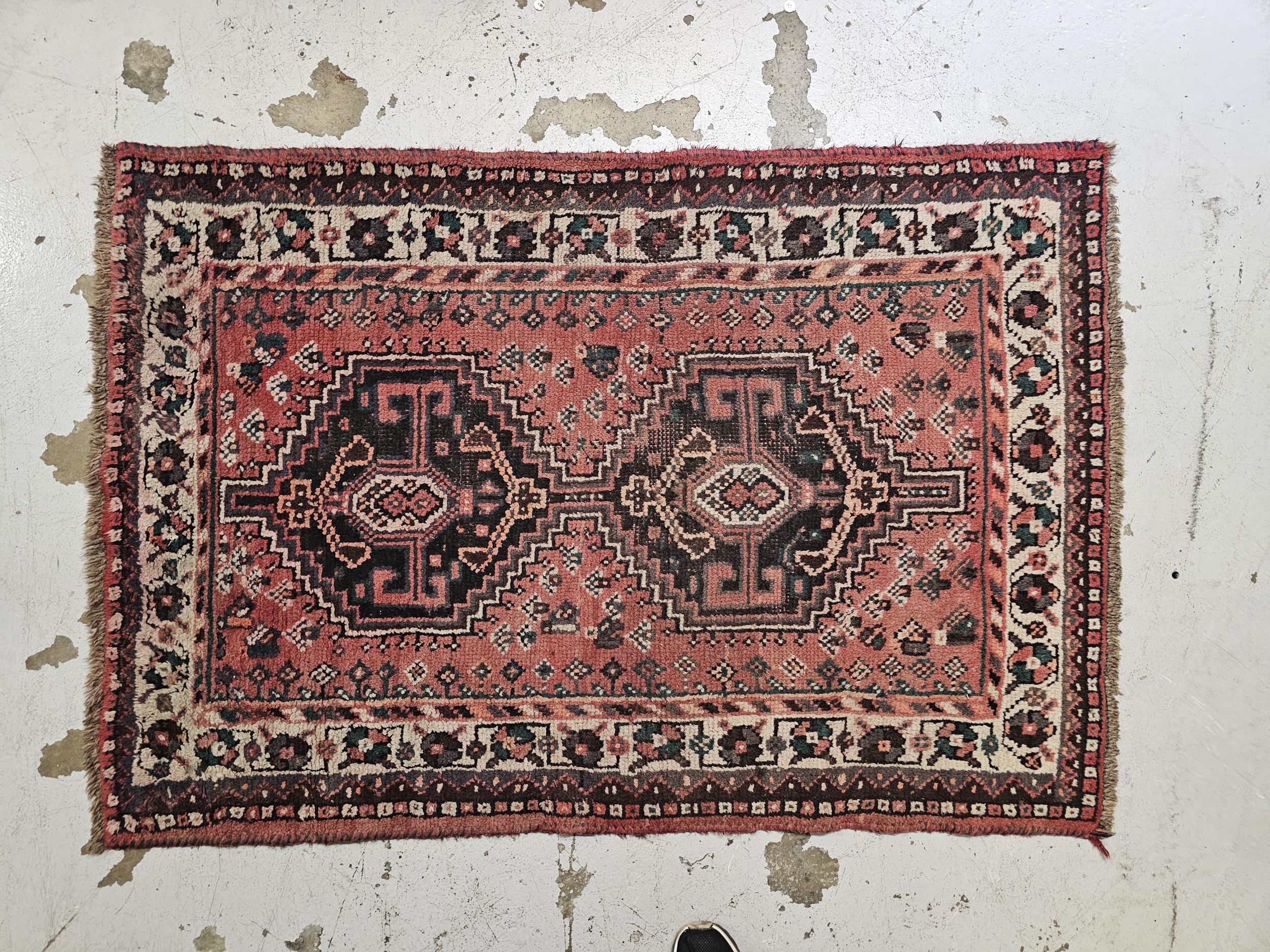 Rug, Persian Karaceh, double lozenge medallion on a burgundy ground. H.160 W.110cm.