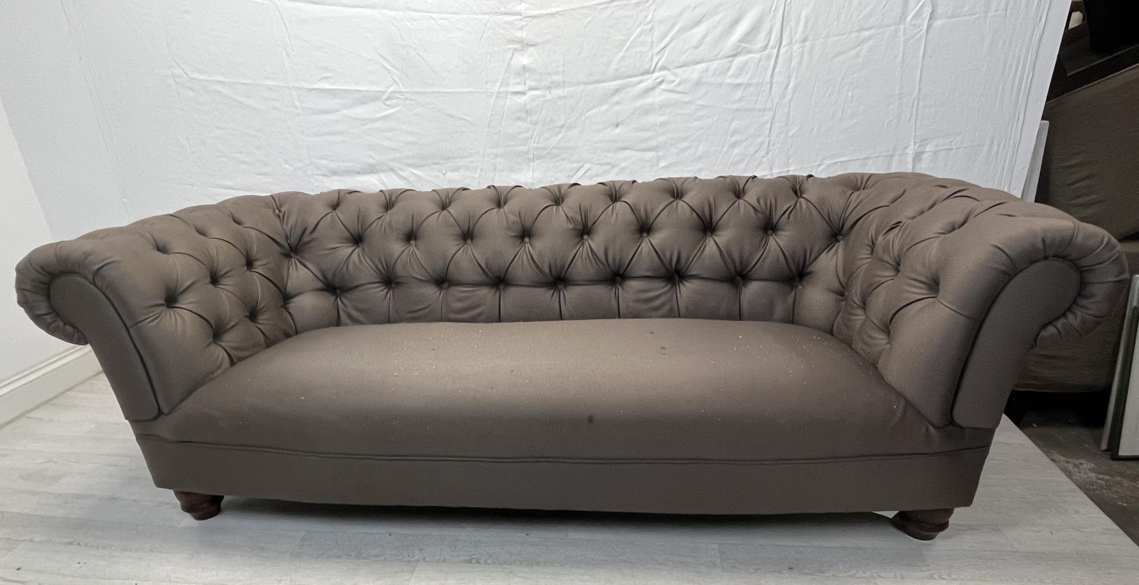 Chesterfield sofa, contemporary on turned supports. (Some stains and burn marks) H.70 W.215 D.90cm.