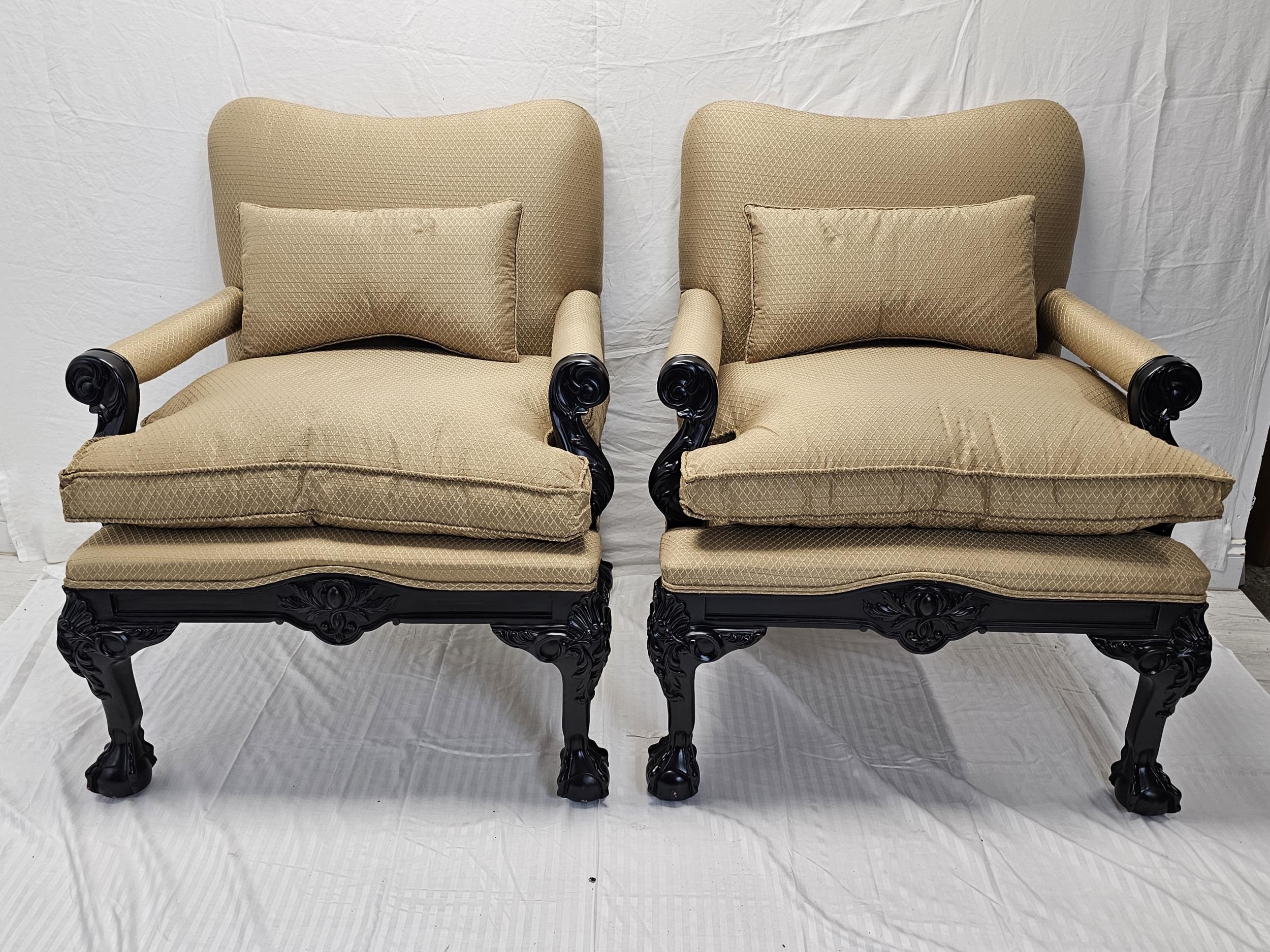 A pair of contemporary (new and unused) early Georgian armchairs with carved ebonised frames.