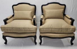 A pair of contemporary (as new) Louis XV style ebonised armchairs.