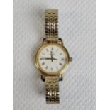 A Ladies 18ct yellow gold Omega quartz watch with Longines movement. Stretch bracelet and date