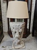 A large composite stone lion mask table lamp. H.105 W.44 D.44cm. (Height includes shade).