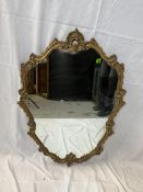 A mid century Rococo style wall mirror in gilt frame. H.81 W.59cm.