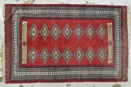 Rug, Turkomen on a burgundy field. H.206 W.102cm.