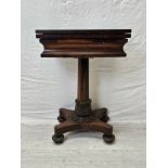 A William IV rosewood fold over top chess and card table raised on faceted column and acanthus