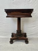 A William IV rosewood fold over top chess and card table raised on faceted column and acanthus