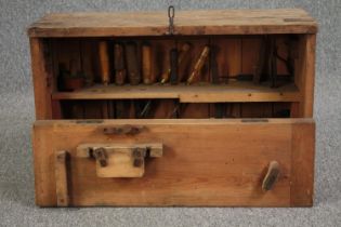 A vintage carpenter's toolbox fitted with chisels and saws etc. H.45 W.70 D.26cm.