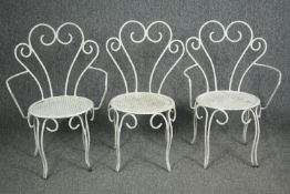 An early 20th century metal and iron garden armchair along with the matching pair of side chairs.