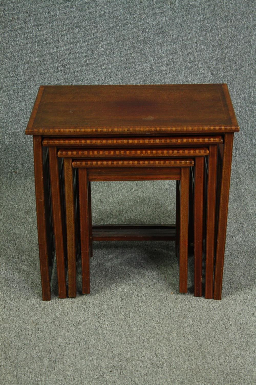 A nest of four graduating Edwardian mahogany and satinwood inlaid occasional tables. H.54 W.56 D.