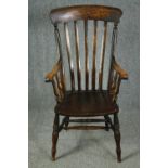 A 19th century beech and elm stick back kitchen armchair. H.114cm.