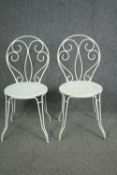 A pair of early 20th century metal and iron garden or conservatory chairs.