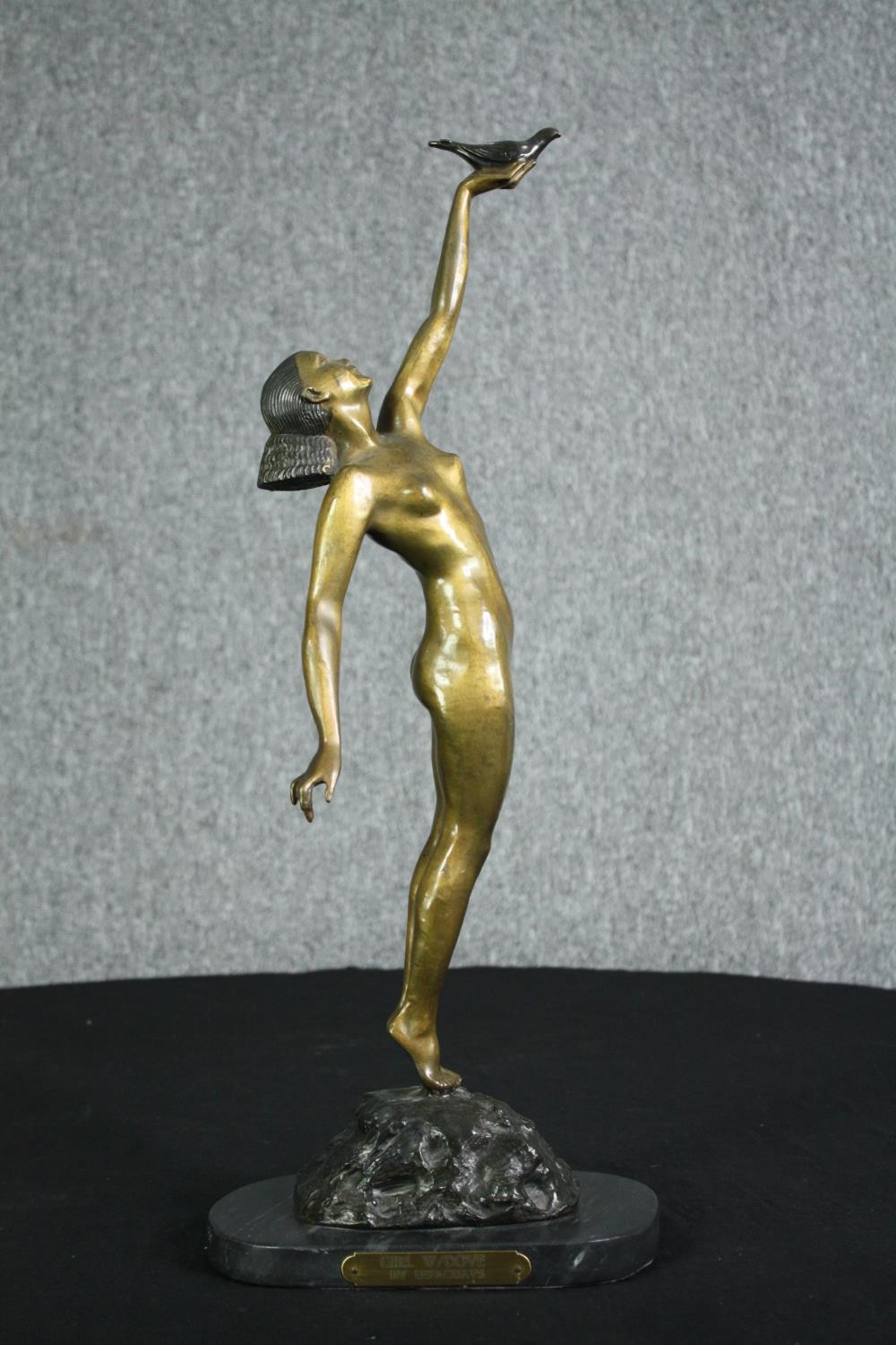 Pierre le Faguays, French (1892 - 1962), a patinated bronze figure, Girl with Dove” H.56cm.