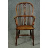 A 19th century elm and yew Windsor armchair with hooped back and pierced splat on turned stretchered