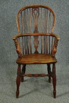 A 19th century elm and yew Windsor armchair with hooped back and pierced splat on turned stretchered