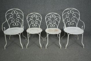 A set of four early 20th century metal and iron garden or conservatory chairs, to include two