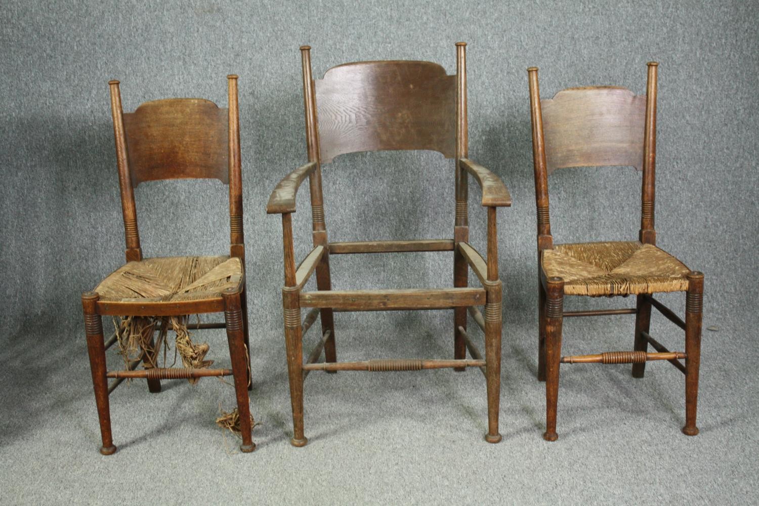 William Birch for Liberty, an Arts and Crafts oak armchair along with two side chairs.